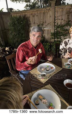 Portrait of a family eating sushi together View Large Photo Image Stock Image - Portrait of a family eating sushi together. Fotosearch