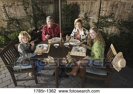 Portrait of a family eating sushi together View Large Photo Image Stock Image - Portrait of a family eating sushi together. Fotosearch