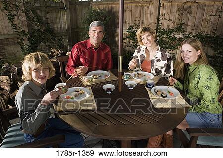 Portrait of a family eating sushi together View Large Photo Image Stock Photo - Portrait of a family eating sushi together. Fotosearch