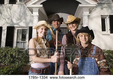 Picture - Portrait of a family in country clothes standing in front of a house. Fotosearch