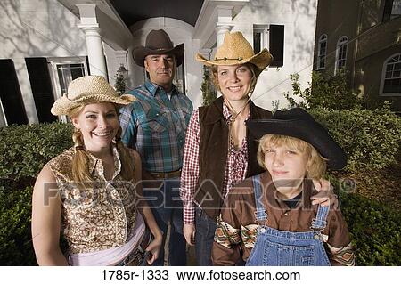 Portrait of a family in country clothes standing in front of a house View Large Photo Image Stock Image - Portrait of a family in country clothes standing in front of a house. Fotosearch