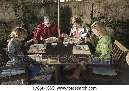 Portrait of a family saying grace before eating sushi together View Large Photo Image Stock Image - Portrait of a family saying grace before eating sushi together. Fotosearch