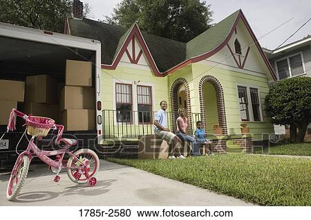 Portrait of a family sitting on boxes outside house and moving truck View Large Photo Image Stock Image - Portrait of a family sitting on boxes outside house and moving truck. Fotosearch