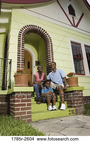 Portrait of a family sitting on front steps of house View Large Photo Image Picture - Portrait of a family sitting on front steps of house. Fotosearch