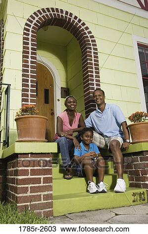 Portrait of a family sitting on front steps of house View Large Photo Image Stock Image - Portrait of a family sitting on front steps of house. Fotosearch