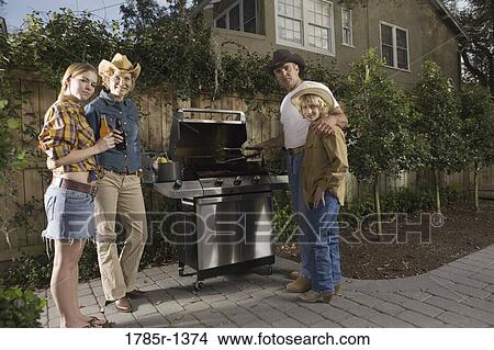 Portrait of a family standing near barbeque grill View Large Photo Image Picture - Portrait of a family standing near barbeque grill. Fotosearch