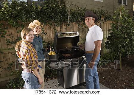 Portrait of a family standing near barbeque grill View Large Photo Image Stock Image - Portrait of a family standing near barbeque grill. Fotosearch