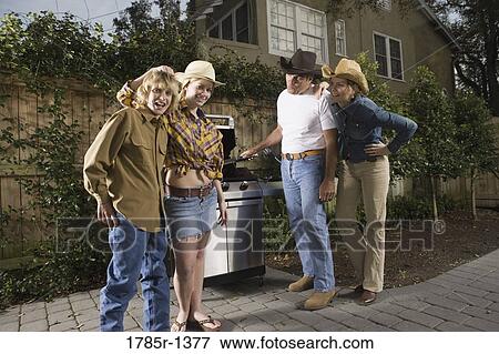 Portrait of a family standing near barbeque grill View Large Photo Image Stock Photo - Portrait of a family standing near barbeque grill. Fotosearch