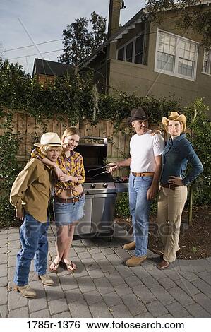 Portrait of a family standing near barbeque grill View Large Photo Image Stock Photograph - Portrait of a family standing near barbeque grill. Fotosearch