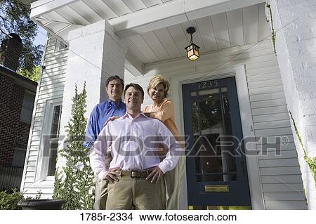 Portrait of a family standing outside a house View Large Photo Image Picture - Portrait of a family standing outside a house. Fotosearch