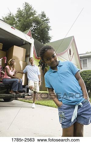 Portrait of a family standing outside a house by moving truck View Large Photo Image Stock Image - Portrait of a family standing outside a house by moving truck. Fotosearch