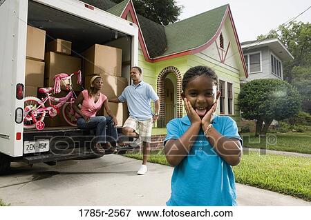 Portrait of a family standing outside a house by moving truck View Large Photo Image Stock Photo - Portrait of a family standing outside a house by moving truck. Fotosearch