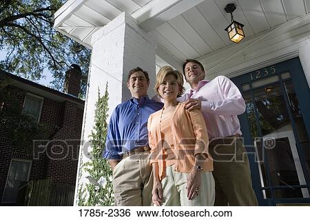 Portrait of a family standing outside a house View Large Photo Image Stock Photograph - Portrait of a family standing outside a house. Fotosearch