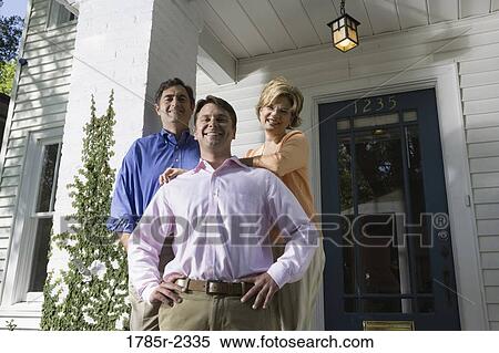 Portrait of a family standing outside a house View Large Photo Image Stock Photography - Portrait of a family standing outside a house. Fotosearch