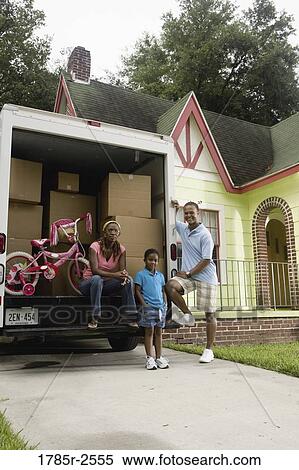 Portrait of a family standing outside a house by moving truck View Large Photo Image Stock Photography - Portrait of a family standing outside a house by moving truck. Fotosearch