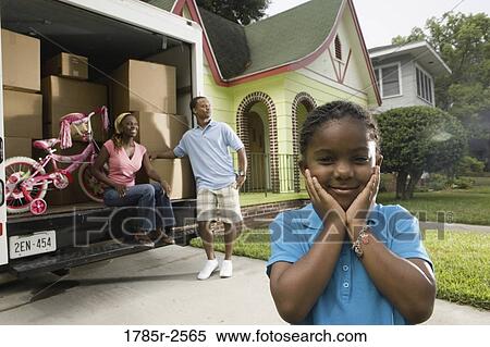 Portrait of a family standing outside a house by moving truck View Large Photo Image Stock Photography - Portrait of a family standing outside a house by moving truck. Fotosearch