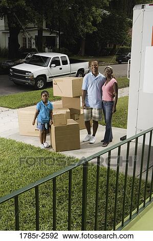 Portrait of a family standing with cartons in driveway View Large Photo Image Stock Image - Portrait of a family standing with cartons in driveway. Fotosearch