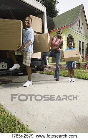 Portrait of a family unloading boxes from moving truck View Large Photo Image Stock Photo - Portrait of a family unloading boxes from moving truck. Fotosearch