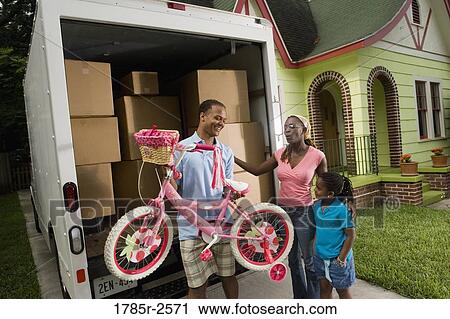 Portrait of a family unloading their belongings from a moving truck View Large Photo Image Stock Image - Portrait of a family unloading their belongings from a moving truck. Fotosearch