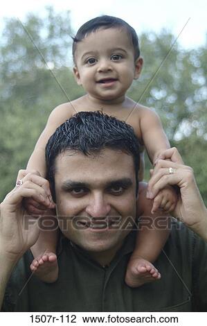 Portrait of a father carrying his baby boy on his shoulders View Large Photo Image Stock Image - Portrait of a father carrying his baby boy on his shoulders. Fotosearch
