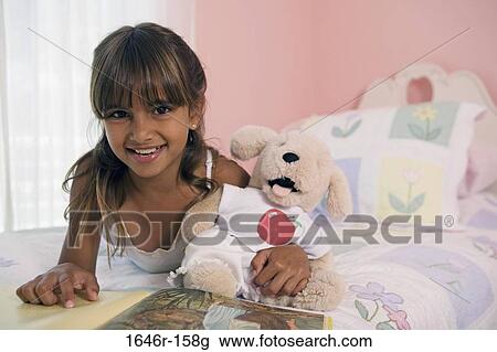 Portrait of a girl lying in the bed and smiling View Large Photo Image Stock Image - Portrait of a girl lying in the bed and smiling. Fotosearch