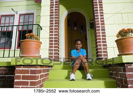 Portrait of a girl sitting on front steps of house View Large Photo Image Stock Image - Portrait of a girl sitting on front steps of house. Fotosearch