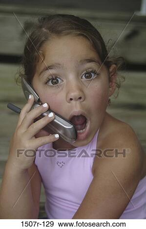 Stock Photo - Portrait of a girl talking on a mobile phone. Fotosearch