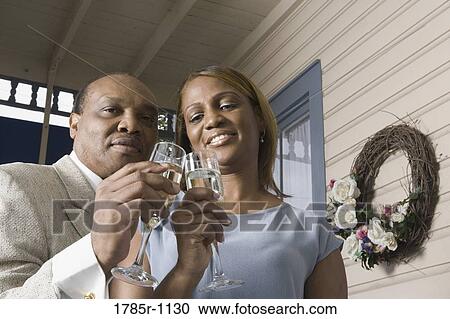 Portrait of a mature couple toasting with champagne View Large Photo Image Stock Image - Portrait of a mature couple toasting with champagne. Fotosearch