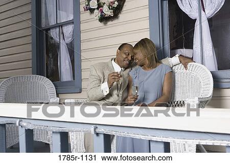 Stock Image - Portrait of a mature couple toasting with champagne. Fotosearch