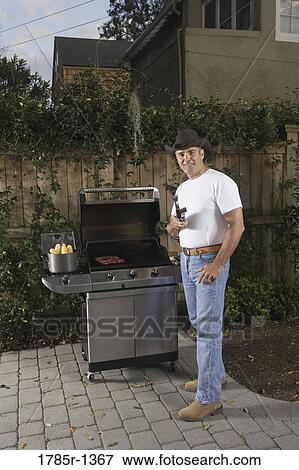 Portrait of a mature man grilling steak View Large Photo Image Stock Photo - Portrait of a mature man grilling steak. Fotosearch