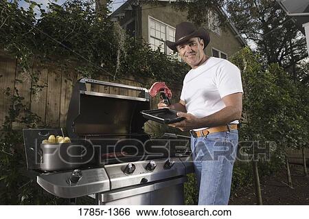 Portrait of a mature man holding steak next to barbeque grill View Large Photo Image Stock Photograph - Portrait of a mature man holding steak next to barbeque grill. Fotosearch