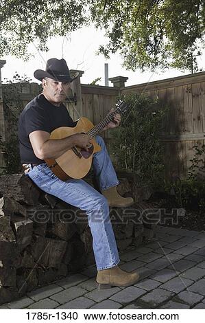 Portrait of a mature man playing guitar View Large Photo Image Stock Image - Portrait of a mature man playing guitar. Fotosearch