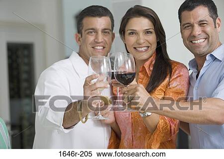 Portrait of a mid adult woman toasting with wineglasses with her friends View Large Photo Image Stock Photography - Portrait of a mid adult woman toasting with wineglasses with her friends. Fotosearch