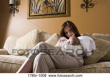 Portrait of a mother feeding infant with a bottle View Large Photo Image Stock Photo - Portrait of a mother feeding infant with a bottle. Fotosearch