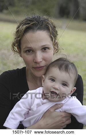 Portrait of a mother holding her baby boy View Large Photo Image Stock Photo - Portrait of a mother holding her baby boy. Fotosearch