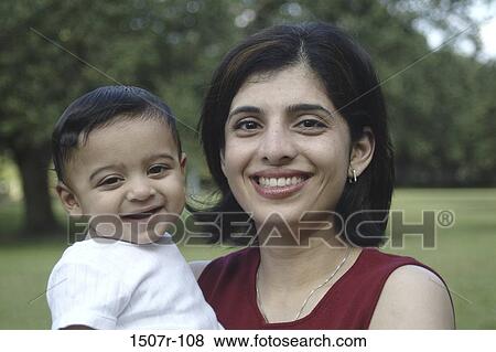 Portrait of a mother holding her baby boy View Large Photo Image Stock Photo - Portrait of a mother holding her baby boy. Fotosearch