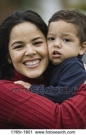 Portrait of a mother holding son View Large Photo Image Stock Image - Portrait of a mother holding son. Fotosearch