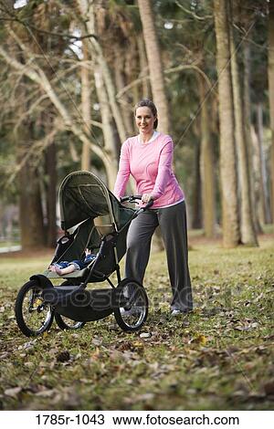 Portrait of a mother with baby in a stroller View Large Photo Image Stock Image - Portrait of a mother with baby in a stroller. Fotosearch