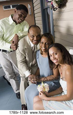 Portrait of a smiling family View Large Photo Image Stock Photo - Portrait of a smiling family. Fotosearch