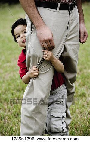 Stock Photograph - Portrait of a son holding his father by his leg. Fotosearch