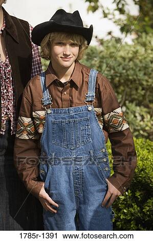 Stock Image - Portrait of a teenage boy in country clothes smiling. Fotosearch