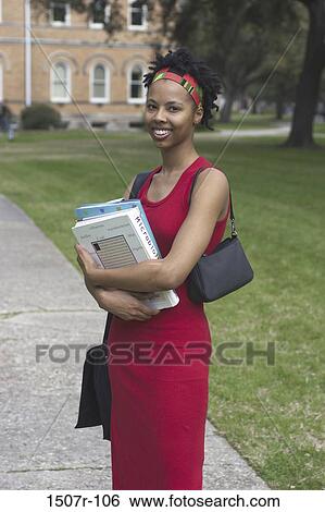 Portrait of a teenage girl holding books View Large Photo Image Stock Photograph - Portrait of a teenage girl holding books. Fotosearch