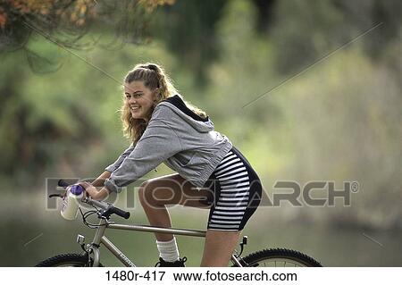 Stock Photo - Portrait of a teenage girl riding a bicycle. Fotosearch
