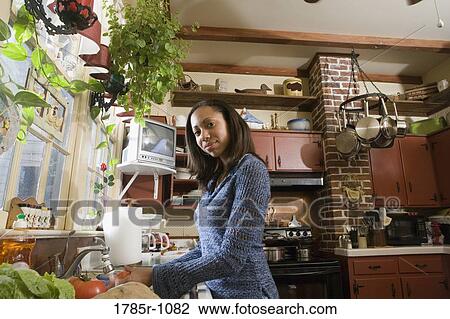 Portrait of a woman washing vegetables in kitchen View Large Photo Image Stock Image - Portrait of a woman washing vegetables in kitchen. Fotosearch