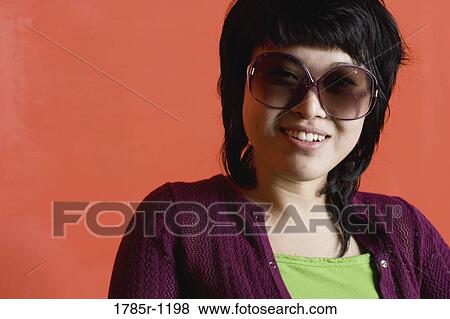 Stock Photo - Portrait of a young Asian woman smiling. Fotosearch