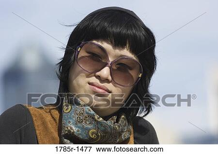Portrait of a young Asian woman smiling View Large Photo Image Stock Photo - Portrait of a young Asian woman smiling. Fotosearch