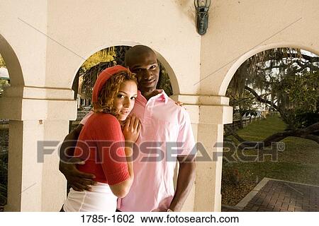 Portrait of a young couple embracing in a gazebo View Large Photo Image Stock Image - Portrait of a young couple embracing in a gazebo. Fotosearch