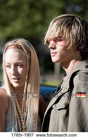 Portrait of a young couple in vintage 1960's hippie costumes standing together View Large Photo Image Stock Photo - Portrait of a young couple in vintage 1960's hippie costumes standing together. Fotosearch