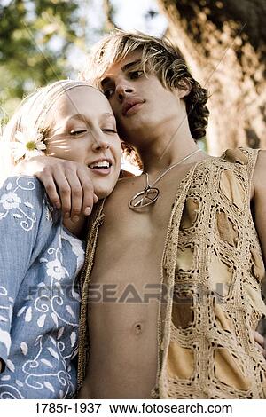 Portrait of a young couple in vintage 1960's hippie costumes embracing View Large Photo Image Stock Photo - Portrait of a young couple in vintage 1960's hippie costumes embracing. Fotosearch