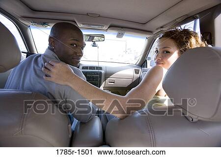 Portrait of a young couple sitting in a car View Large Photo Image Stock Image - Portrait of a young couple sitting in a car. Fotosearch